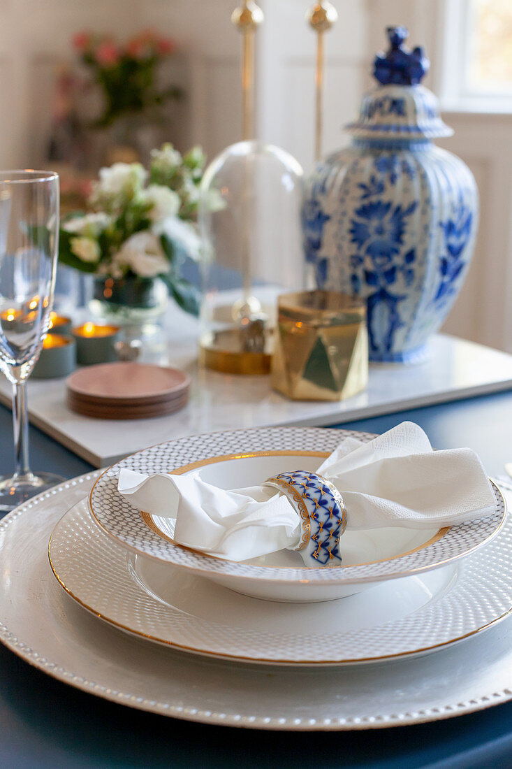 Elegant gold-rimmed china on classically set table