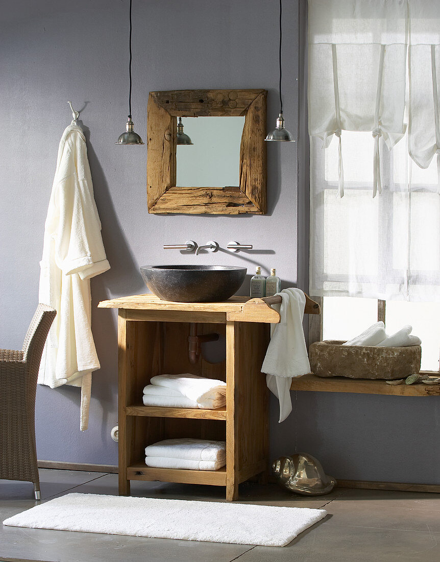 Rustic bathroom with stone sink on wooden table