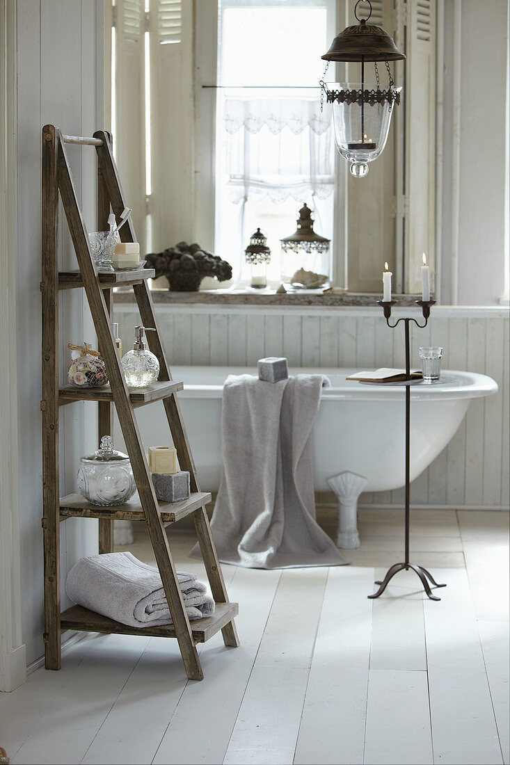 Ladder-style shelves and free-standing bathtub in romantic bathtub