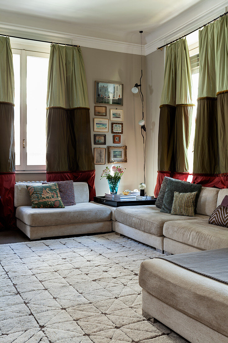 Pale sofa set in living room with tri-coloured curtains