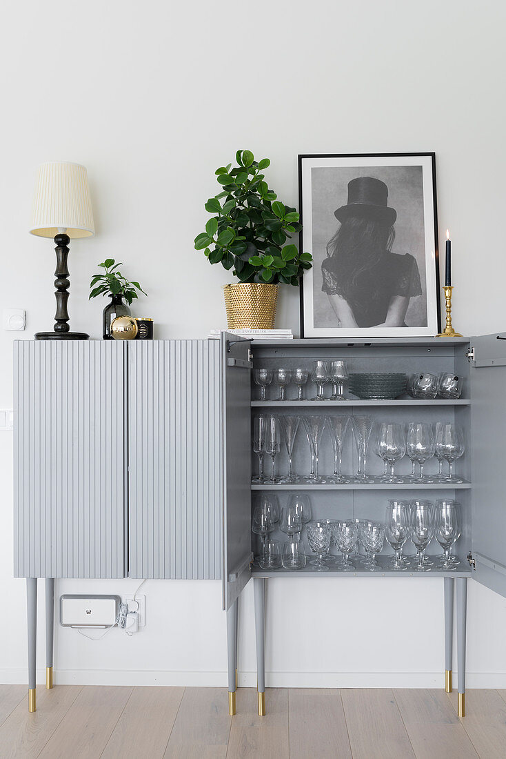Glasses in pale-grey cabinet with tall legs
