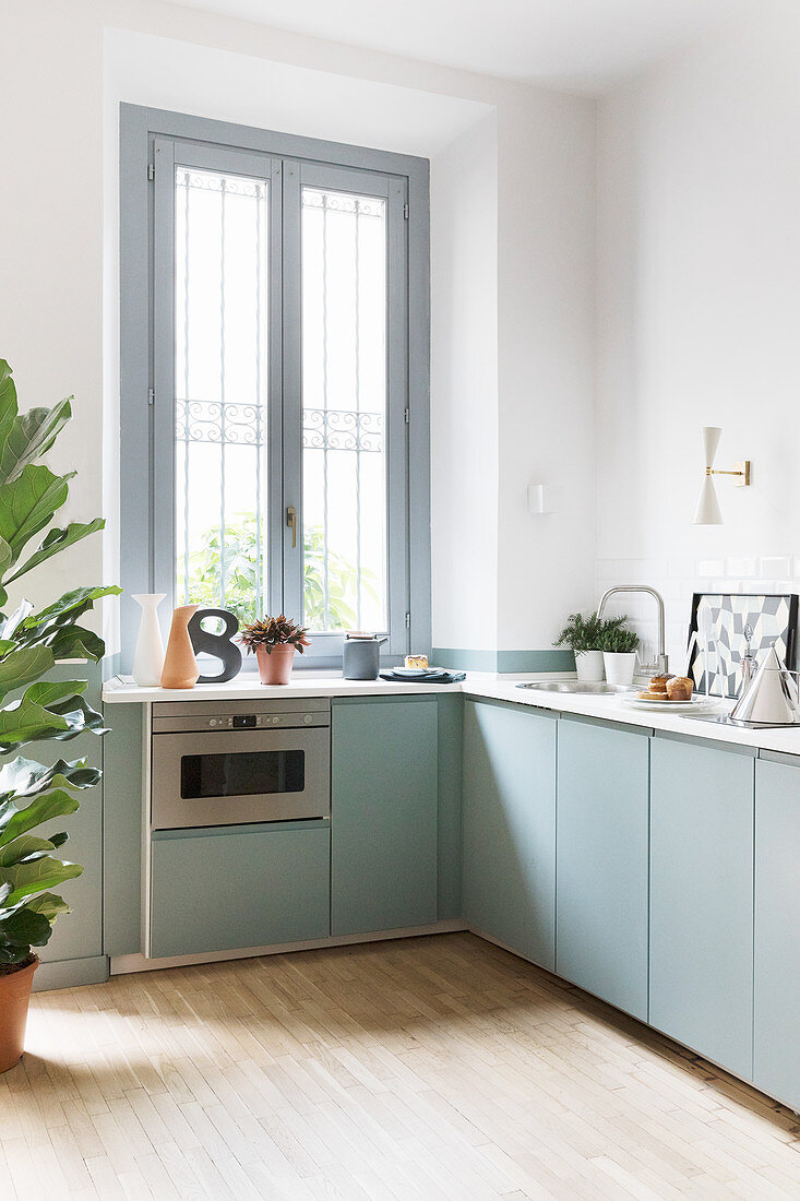 Modern kitchen with pale blue cupboards and clean lines