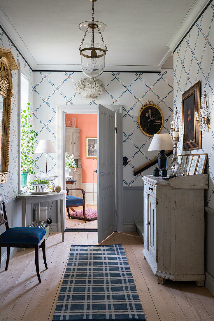 White wooden furniture in hallway of renovated Swedish house