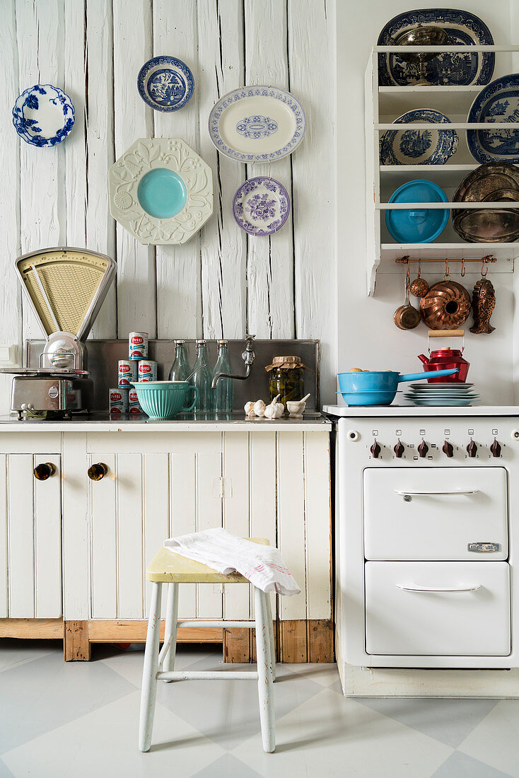Vintage kitchen with plate rack and decorative wall plates on wall