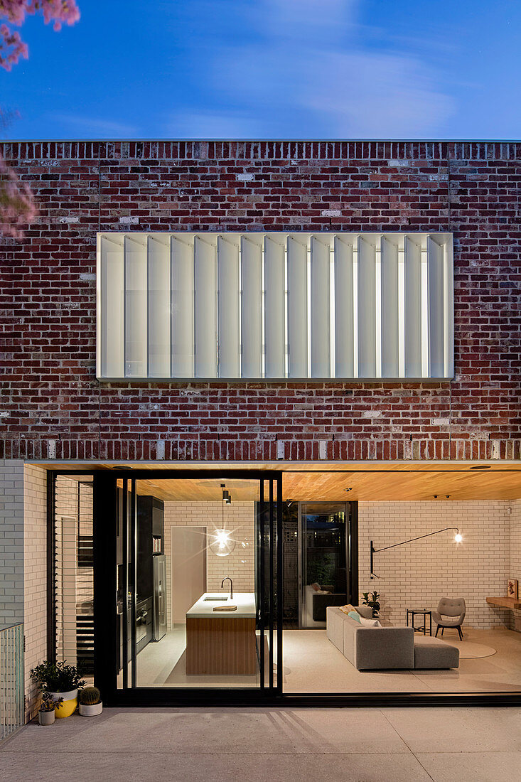 Modern brick house with window front to the open living room