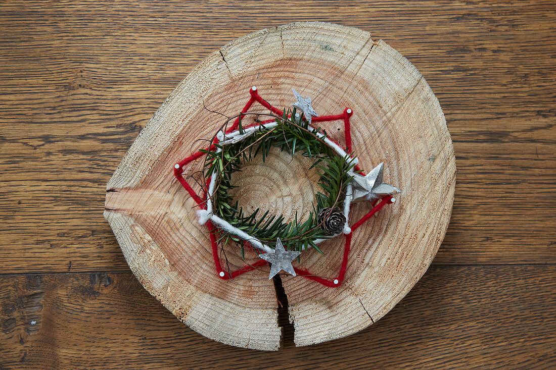 Rustic star made from nails and felt yarn and wreath on wooden board