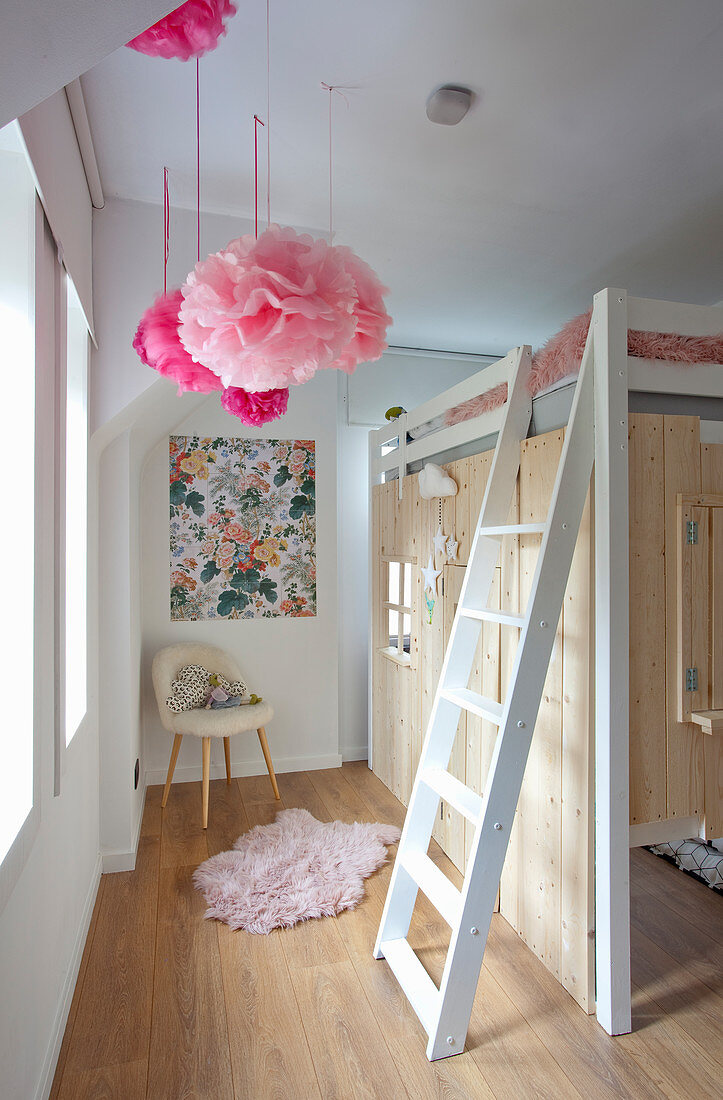 Play house with wooden walls under loft bed in child's bedroom