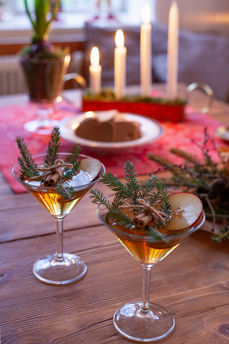 Zwei weihnachtlich dekorierte Cocktails auf rustikalem Holztisch