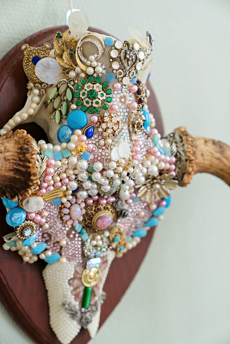 Animal skull richly decorated with beads and brooches