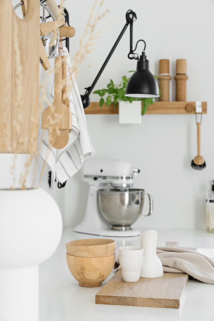 Various kitchen utensils on worksurface in white Scandinavian kitchen