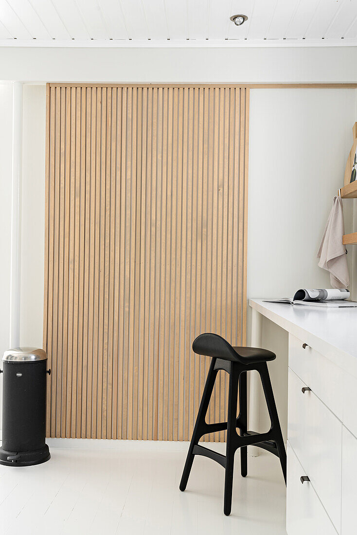 Wall panel of wooden slats in white Scandinavian kitchen