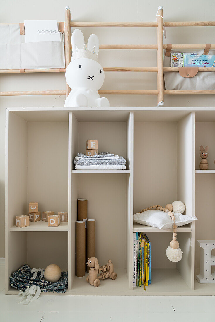 Wooden shelves with storage compartments in child's bedroom