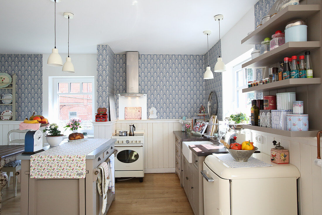 White wainscoting and patterned wallpaper in romantic country-house kitchen
