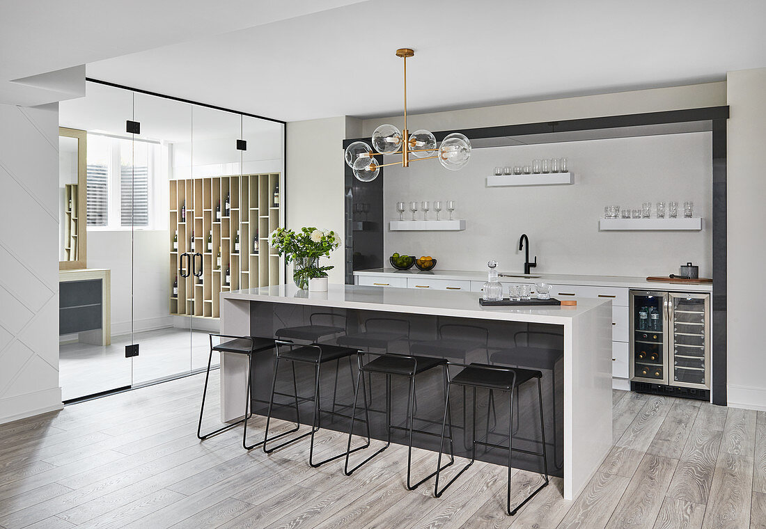Bar and black bar stools in open-plan kitchen