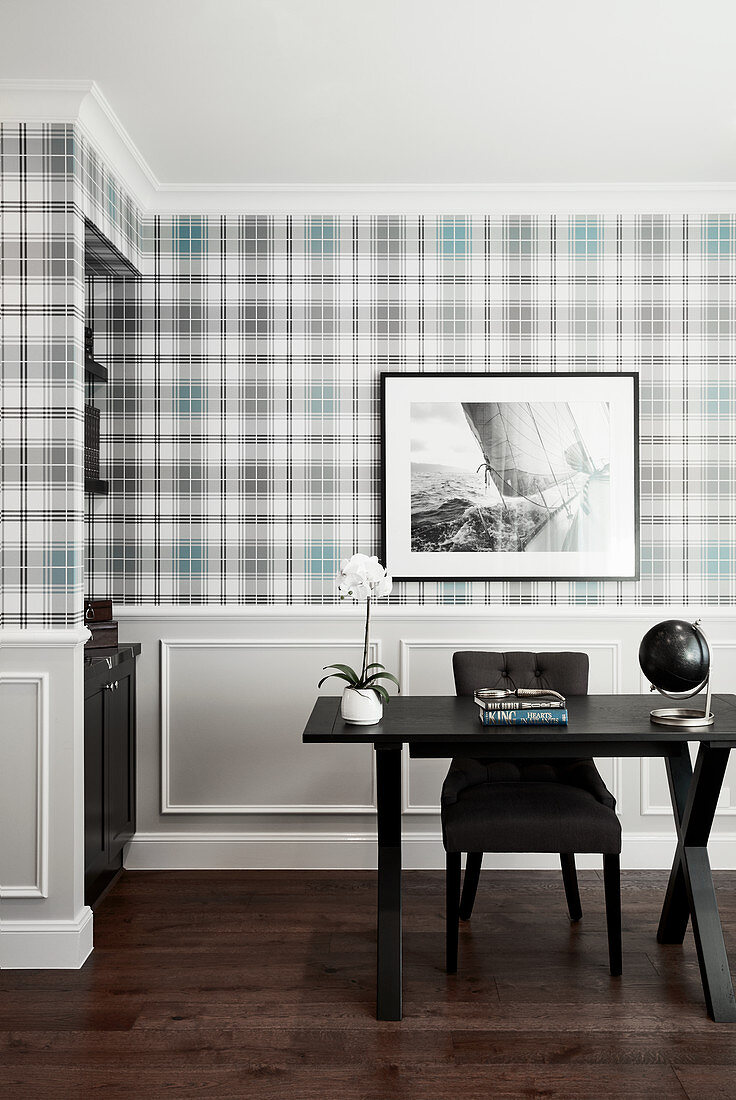 Desk in front of wall with tartan wallpaper and panelled wainscoting
