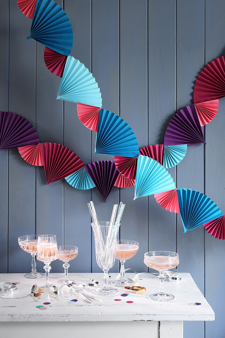 Colourful garland of paper fans above party buffet