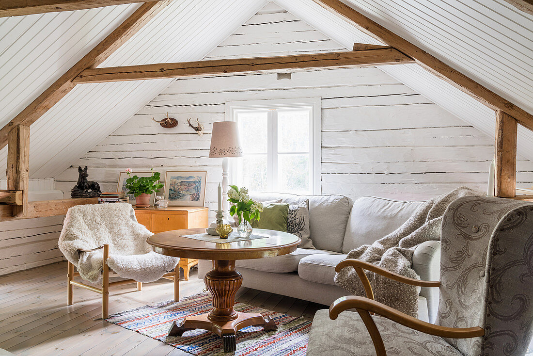 Cosy seating area in converted attic of Swedish house