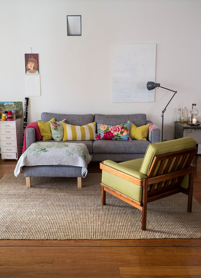 Grey sofa with scatter cushions, matching ottoman and lime-green armchair