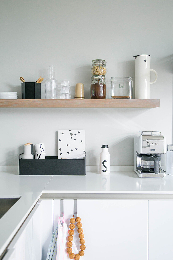 Kitchen utensils on shelves in minimalist, modern kitchen