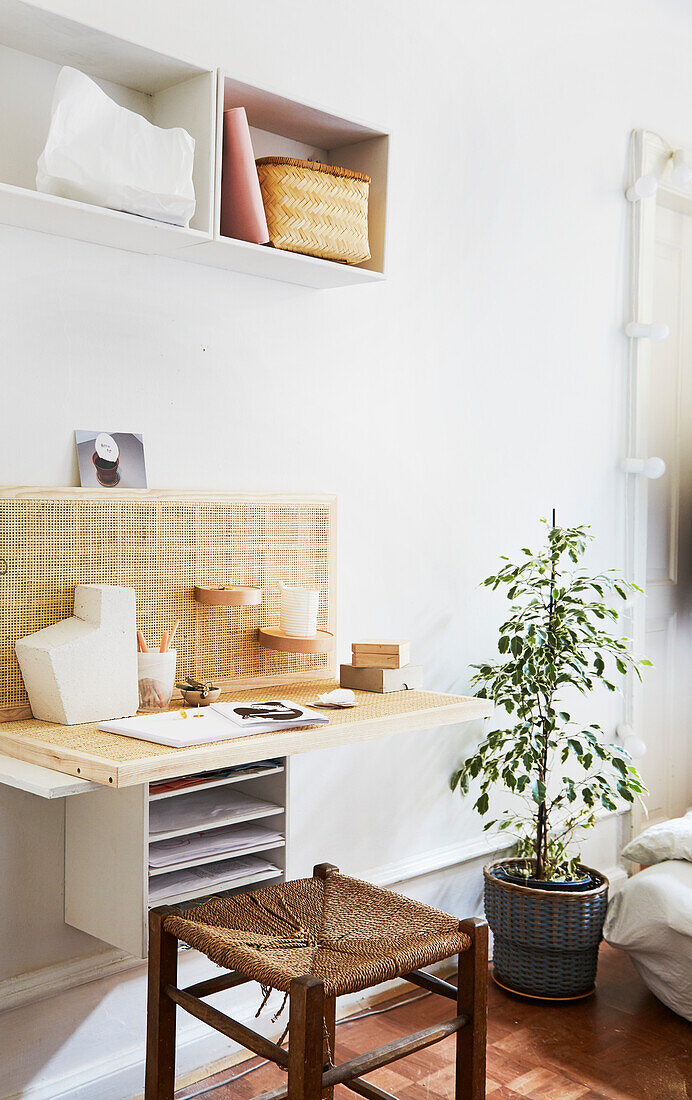 Old stool at desk with woven wall panel