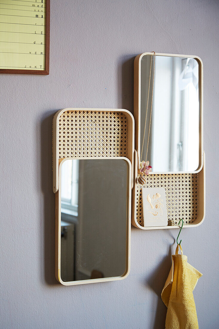 Mirrors with handmade woven cane panels mounted on wall