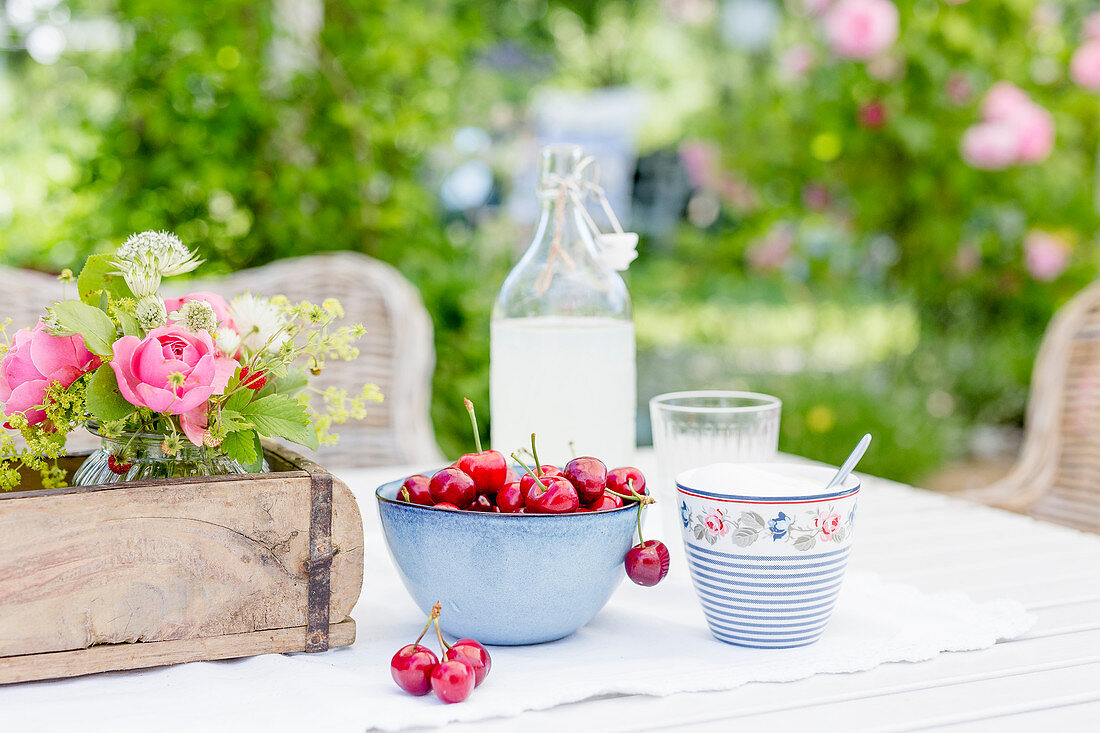 Cherries and lemonade on garden table