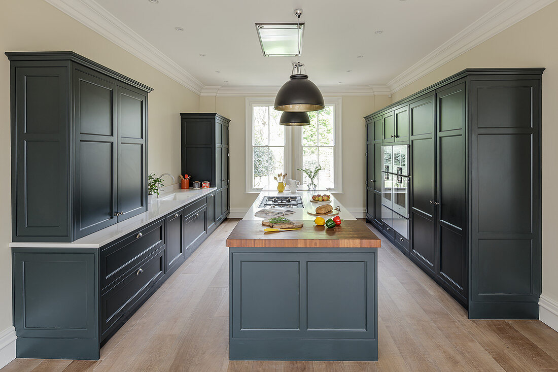 Island counter in elegant kitchen with grey furnishings