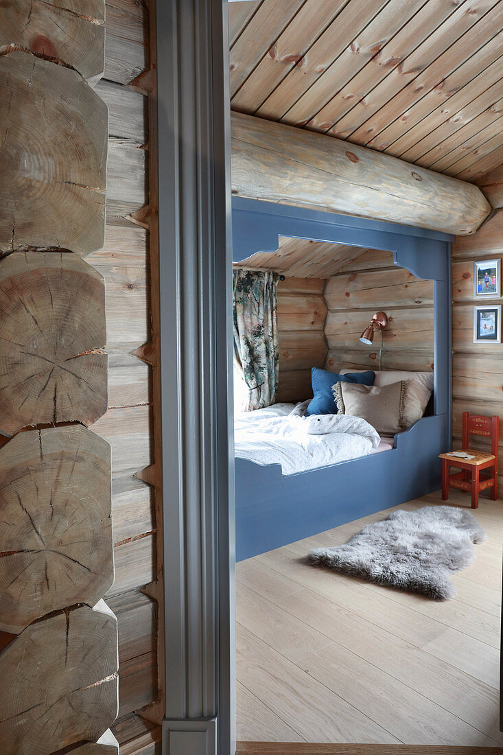 View of cubby bed in bedroom in log cabin