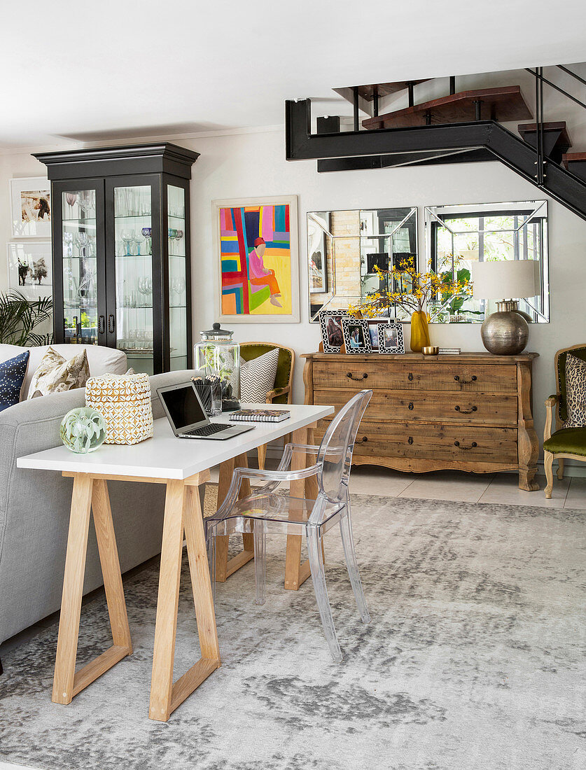 Transparent chair at desk on trestles in living room