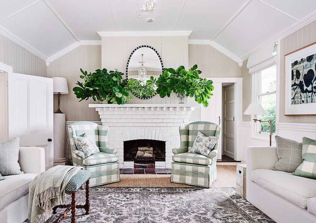 Cottage style living room with checkered upholstered armchairs in front of a white fireplace