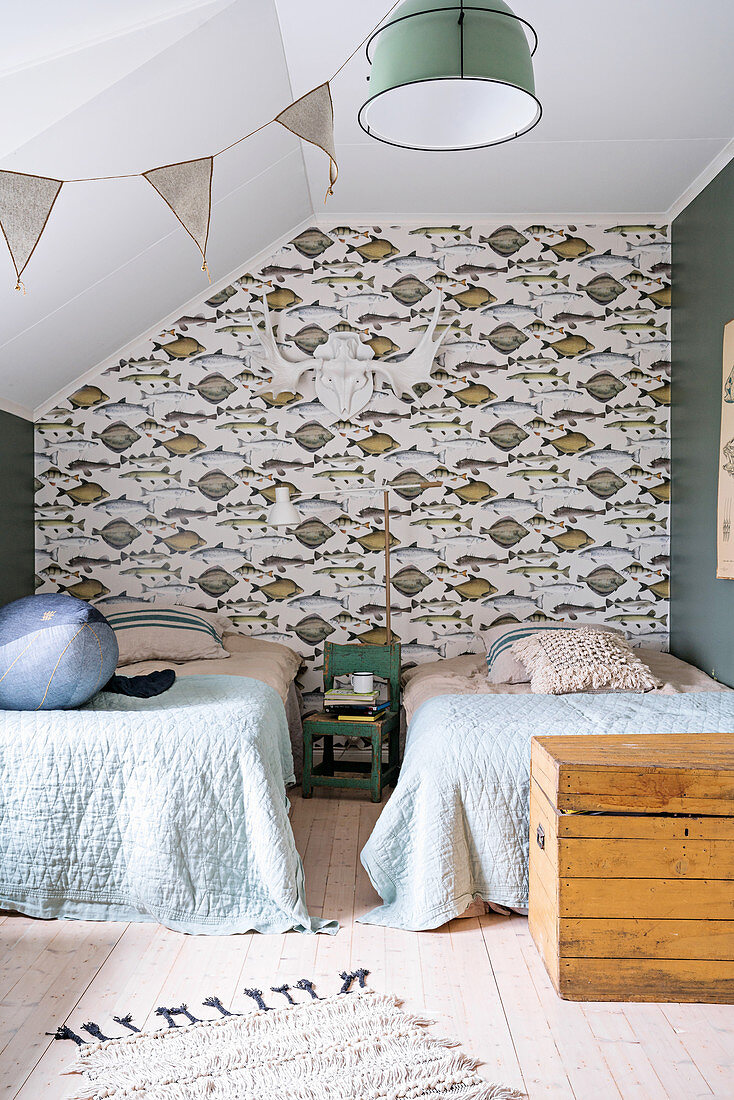 Zwei Einzelbetten und Tapete mit Fischmuster im Schlafzimmer
