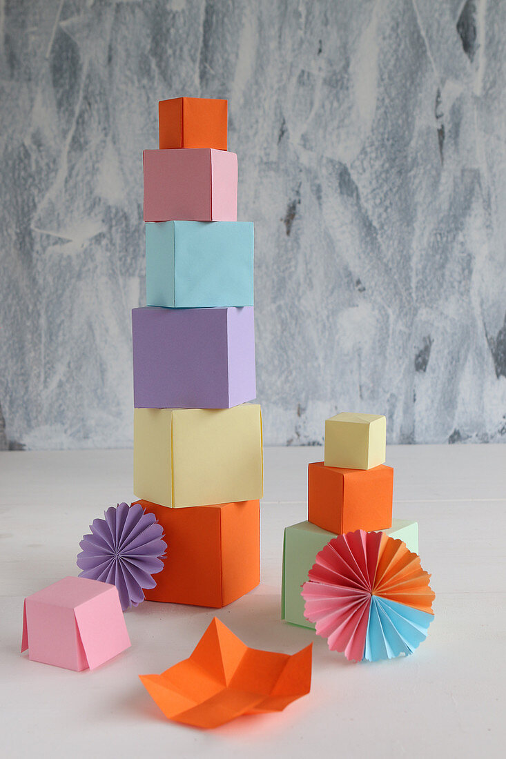 Tower of colourful paper cubes and paper rosettes