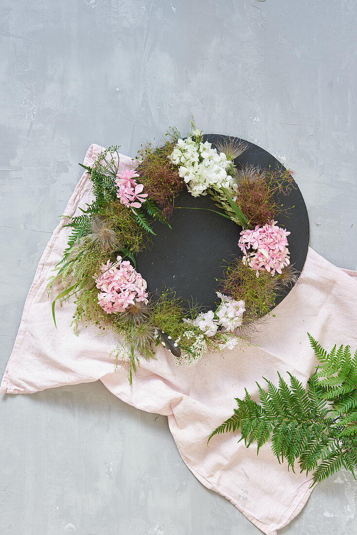 Wreath of flowers and seed heads decorating table