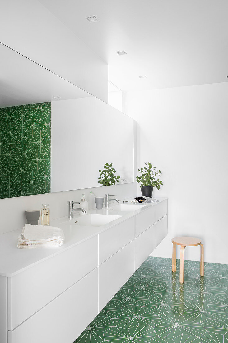 Green tiles with graphic pattern in modern bathroom