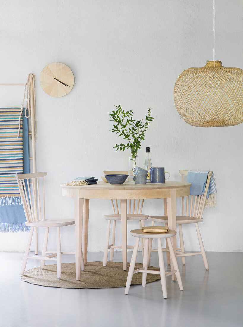 Scandinavian-style dining set in pale wood with blue accessories
