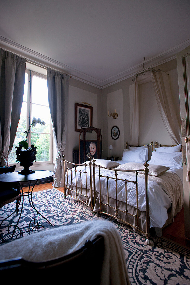 Antique metal beds in stylish beige bedroom