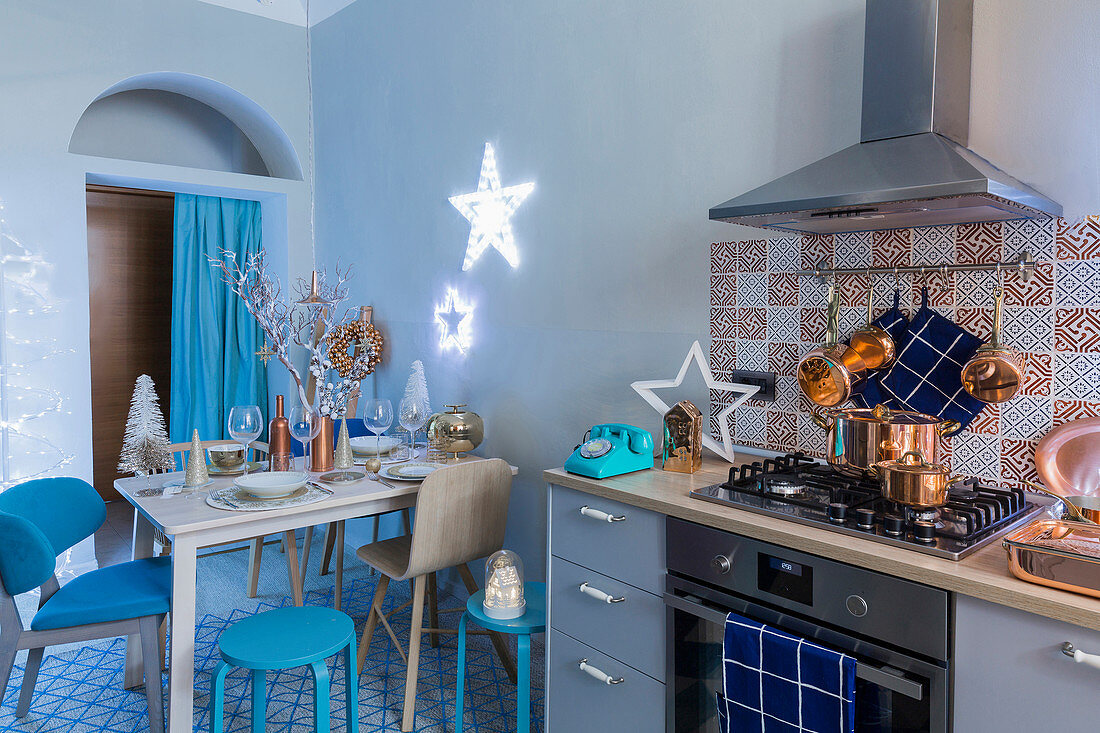 Blaue Küche mit Herd und Esstisch weihnachtlich dekoriert