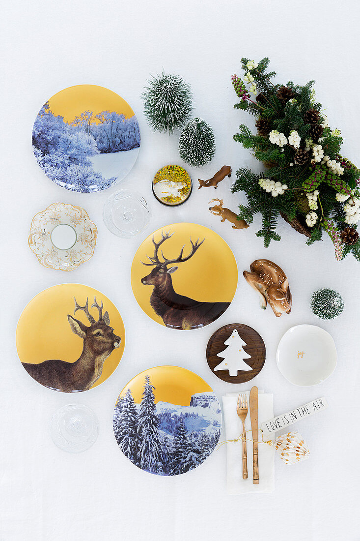 Christmas arrangement of china plates painted with deer and winter landscape motifs