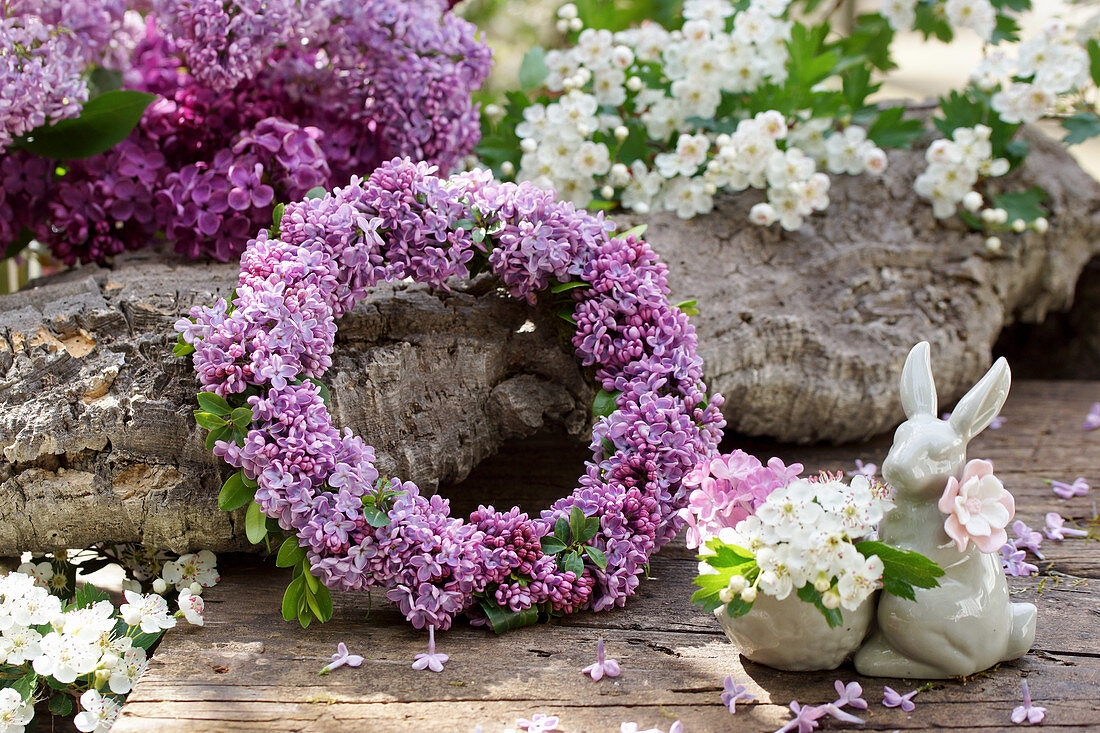 Wreath of lilac blossoms, Easter bunny egg cup with hawthorn blossoms