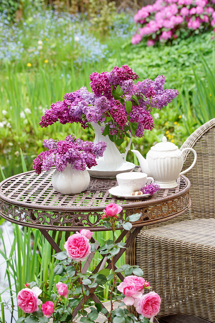 Lilac bouquets on table in the garden