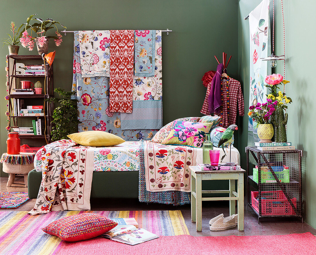 Colourful blankets and scatter cushions on bed