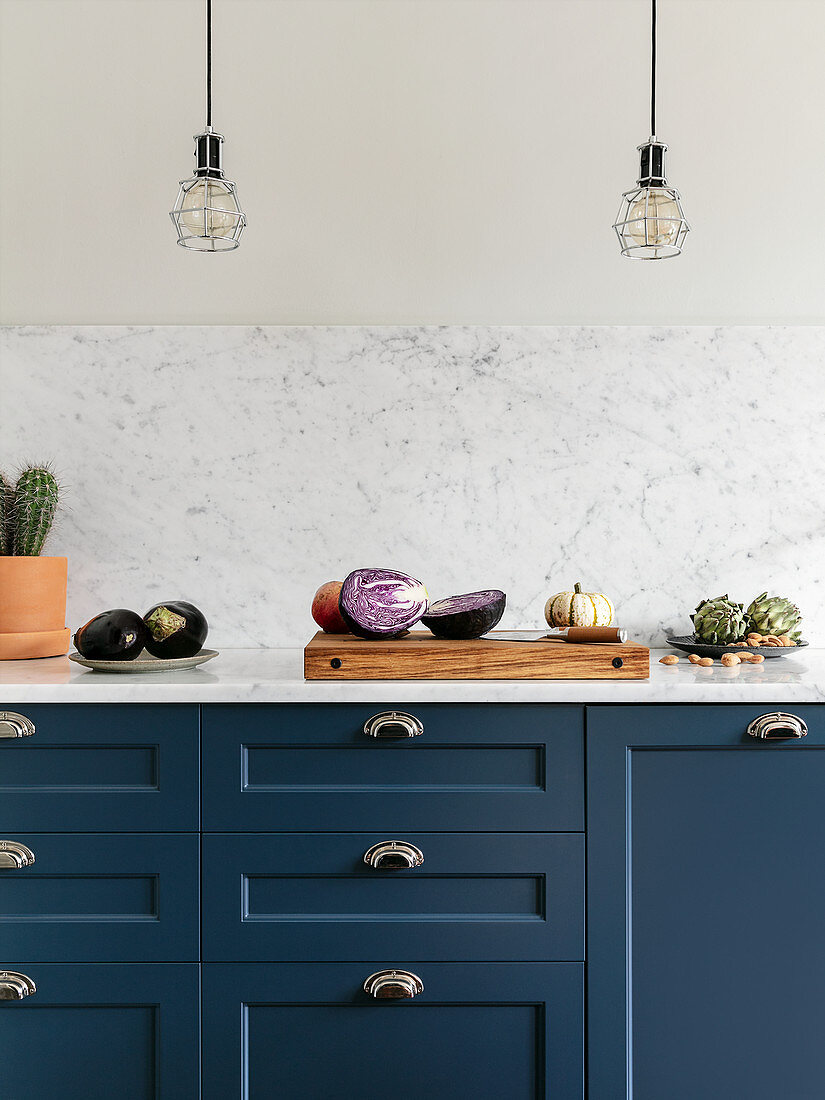 Vegetables on blue kitchen counter with marble worktop