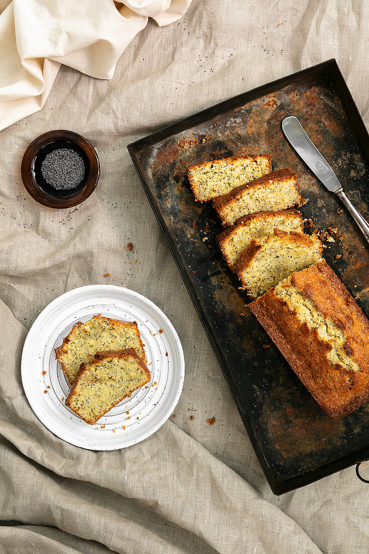 Sliced pound cake on baking tray and plate