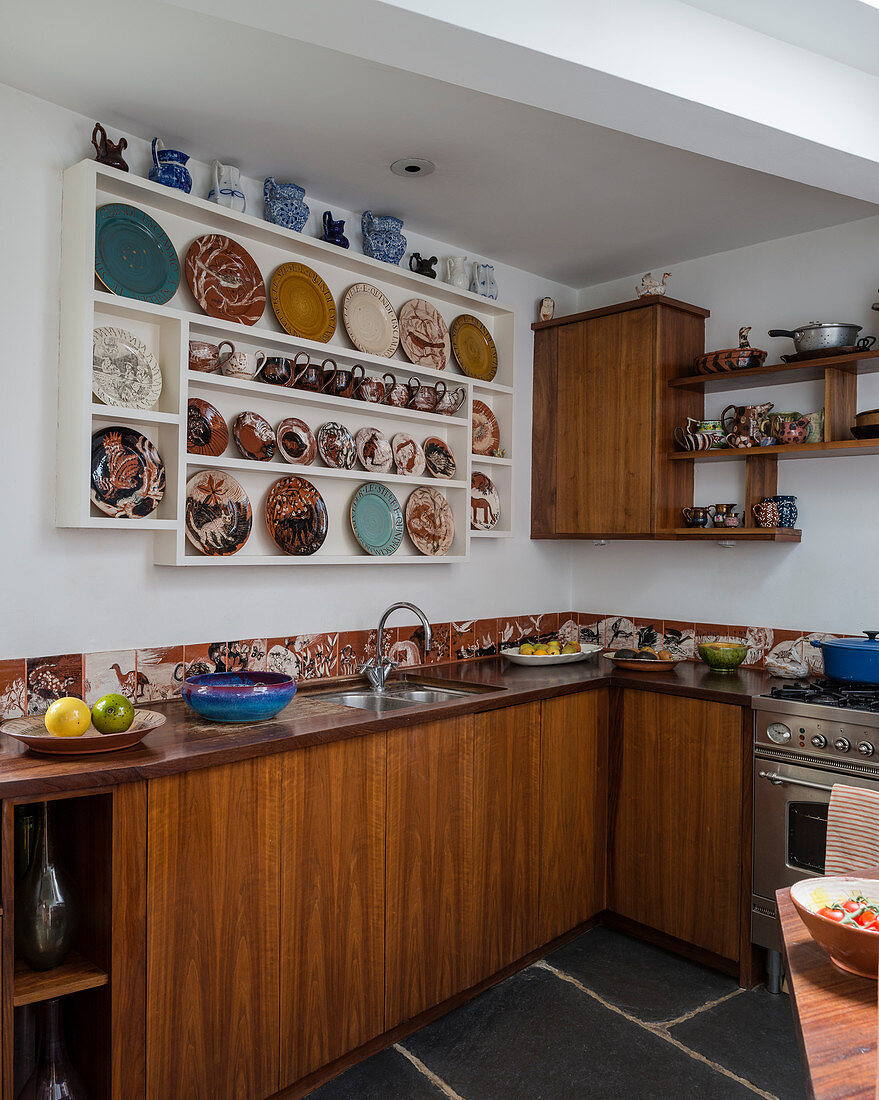 Collection of plates on plate rack in retro kitchen