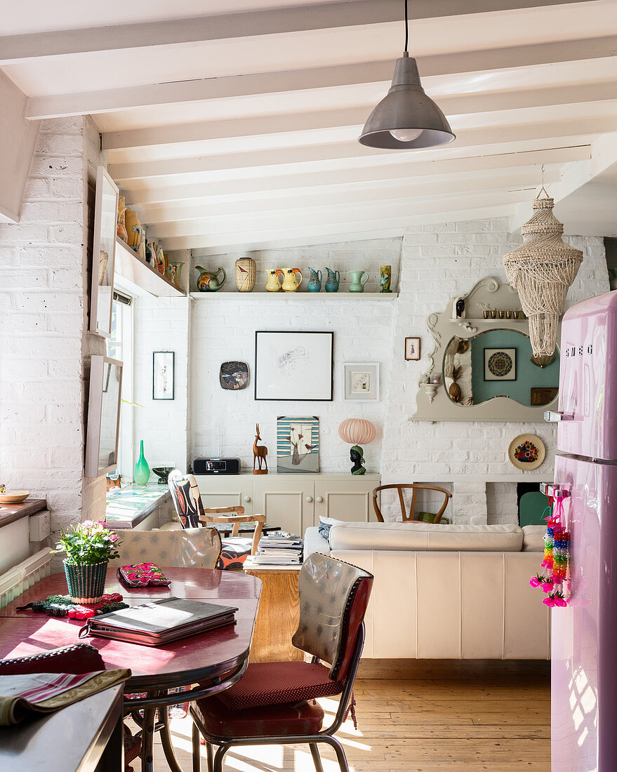 View from open-plan kitchen into eclectic dining area