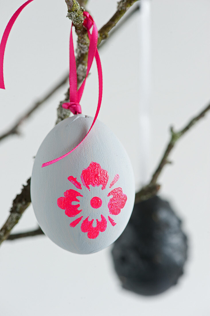 Grey Easter eggs with neon flower motifs