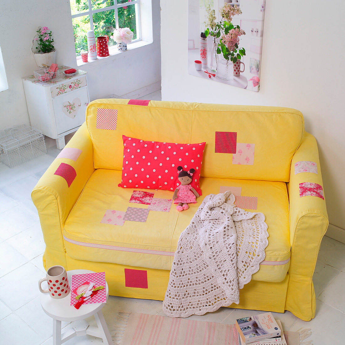 Mit Patchwork aufgemöbeltes, gelbes Sofa im romantischen Wohnzimmer
