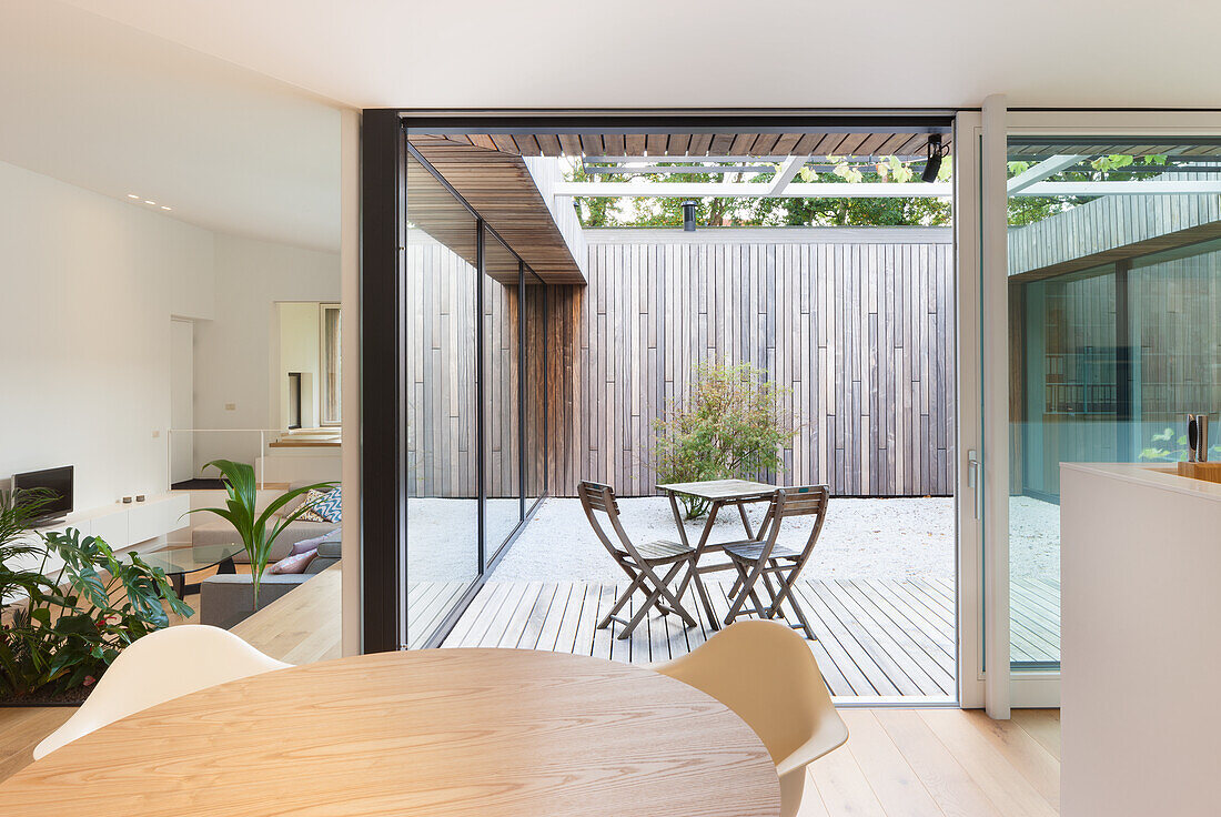 Modern dining room with a view of a minimalist courtyard