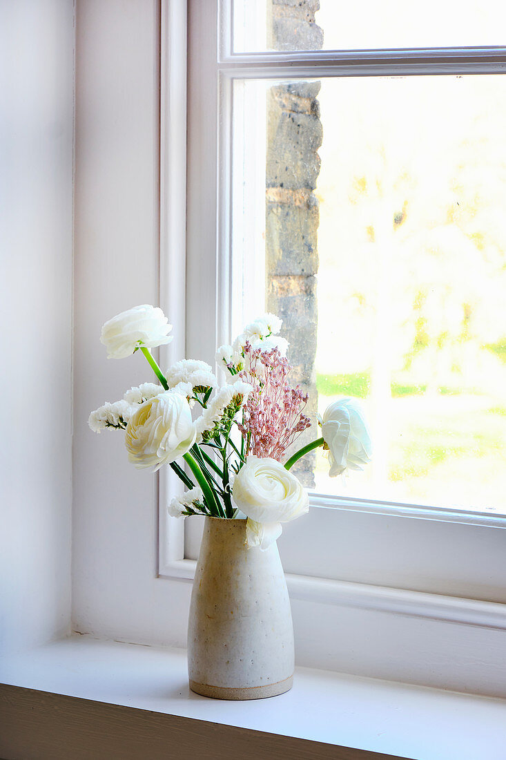 Ceramic vase of white ranunculus