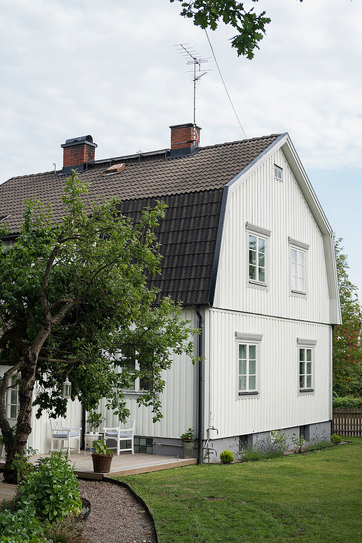 Typisch skandinavisches Landhaus in weiß mit dunklem Dach